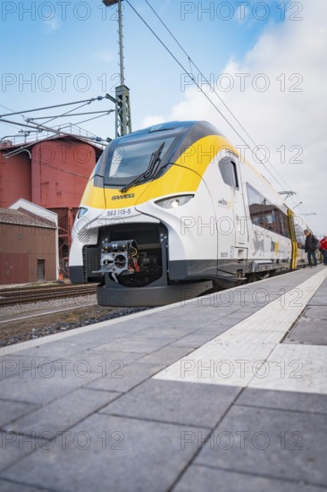 A modern train with a yellow front is on the platform, opening of the Hermann Hesse Railway, Calw, Germany