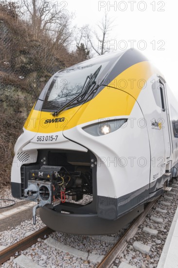 A modern yellow and white train front on the train tracks, opening of the Hermann Hesse Railway, Calw, Germany