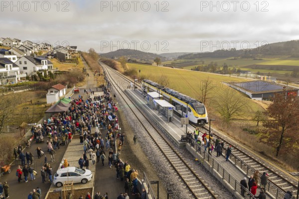 A lively train station in a rural area with lots of people, trains and an idyllic landscape, opening of the Hermann Hesse Railway, Calw, Germany