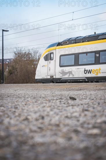 Side view of a modern train surrounded by a wintry atmosphere, opening of the Hermann Hesse Railway, Calw, Germany