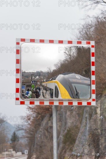 A train in the mirror on a railroad track in a mountainous area, opening of the Hermann Hesse Railway, Calw, Germany
