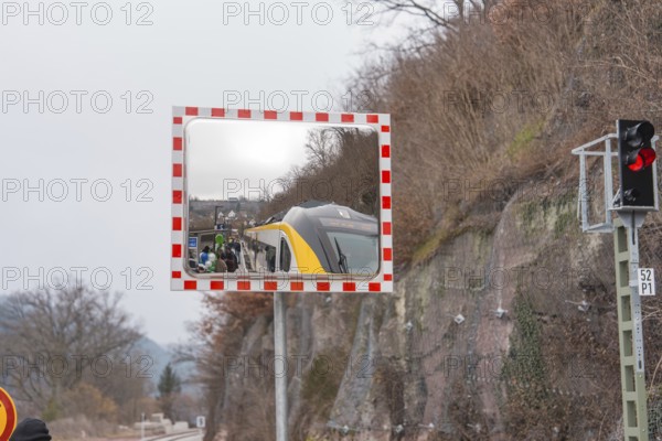 A mirror depicts a train and people waiting in a landscape, opening of the Hermann Hesse Railway, Calw, Germany