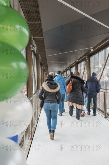 People on a covered bridge with colorful balloons, opening of the Hermann Hesse Railway, Calw, Germany