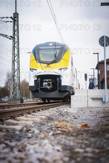 Modern locomotive at close range on railway tracks under grey skies, opening of the Hermann Hesse Railway, Calw, Germany