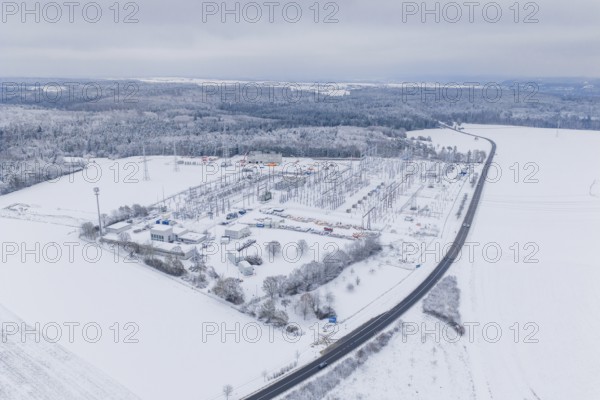 Aerial view of a snowy substation and a wide road in a winter landscape, substation, Jettingen, Germany