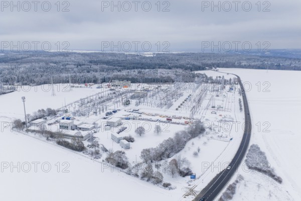 Aerial view of a snowy substation next to a country road in a winter landscape, substation, Jettingen, Germany