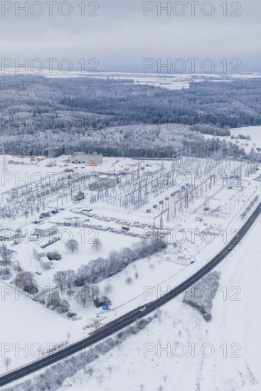 Aerial view of a snowy substation in a vast winter landscape, substation, Jettingen, Germany