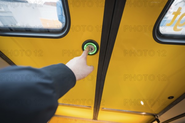 Hand presses button on yellow train door, surrounded by windows, battery electric train Siemens Micro Plus B, Hermann, Hesse, Bahn, Weil der Stadt, Böblingen district, Germany
