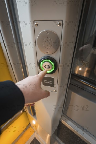 Person presses on the green door button of a modern train, Siemens Micro Plus B battery electric train, Hermann, Hesse, Bahn, Weil der Stadt, Böblingen district, Germany