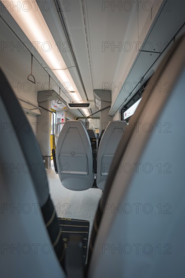 View from the aisle of a modern train with grey seats and lights, Siemens Micro Plus B battery electric train, Hermann, Hesse, Bahn, Weil der Stadt, Böblingen district, Germany