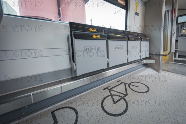 Train compartment with marked bicycle parking spaces and grey folding seats, battery electric train Siemens Micro Plus B, Hermann, Hesse, Bahn, Weil der Stadt, Böblingen district, Germany