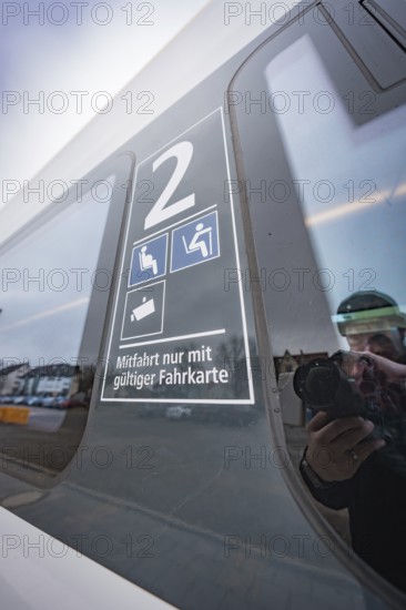 Window reflection with information on valid ticket and seats, battery electric train Siemens Micro Plus B, Hermann, Hesse, Bahn, Weil der Stadt, Böblingen district, Germany