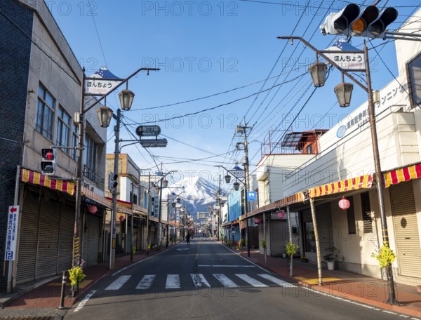 Road through the Japanese town of Fujiyoshida, behind the volcano Mt. Fuji, Yamanashi Prefecture, Japan