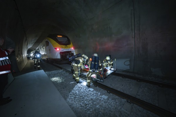 Firefighters during a rescue operation in a dark railway tunnel with a train, fire drill on the Hermann-Hesse Railway, Ostelsheim, Germany