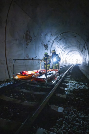 Firefighters stand on an ambulance in a tunnel, equipped for a mission, fire drill on the Hermann-Hesse Railway, Ostelsheim, Germany