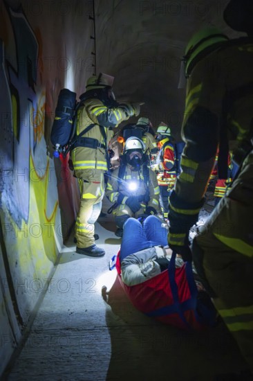 Firefighters provide first aid to an injured person in a dark tunnel, fire drill on the Hermann-Hesse Railway, Ostelsheim, Germany
