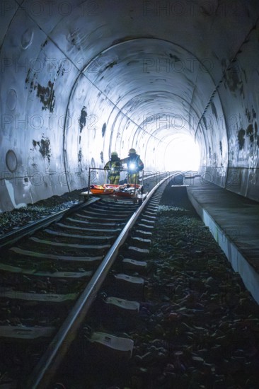 Firefighters on a rail vehicle in a tunnel, light visible at the end, fire drill on the Hermann-Hesse railway, Ostelsheim, Germany