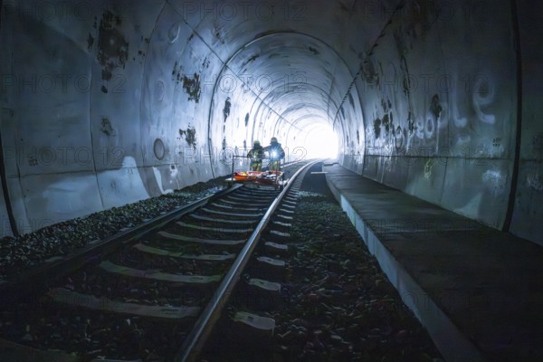 Two firefighters drive an ambulance in a dark tunnel, fire drill on the Hermann-Hesse railway, Ostelsheim, Germany