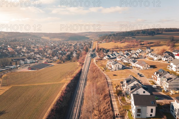 Aerial view of a village and railroad tracks in a far-reaching rural area, fire drill on the Hermann-Hesse railway, Ostelsheim, Germany