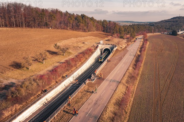 Aerial view of a train near a railway tunnel with emergency services and surrounding landscape, fire drill on the Hermann Hesse Railway, Ostelsheim, Germany
