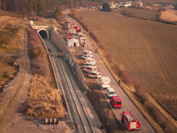 Aerial view of emergency vehicles along a tunnel next to a railway line, fire drill at the Hermann-Hesse Railway, Ostelsheim, Germany