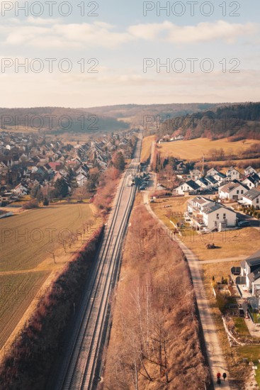 Aerial view of a village with railroad tracks surrounded by fields and hills, fire drill on the Hermann-Hesse railway, Ostelsheim, Germany