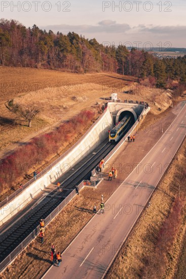 Train leaves a railway tunnel surrounded by emergency services and surrounding countryside, fire drill on the Hermann-Hesse Railway, Ostelsheim, Germany