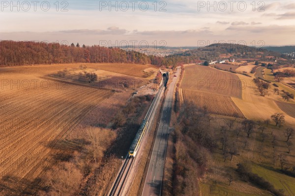Wide landscape with railroad tracks and a distant train, surrounded by fields and forests, fire drill on the Hermann Hesse Railway, Ostelsheim, Germany