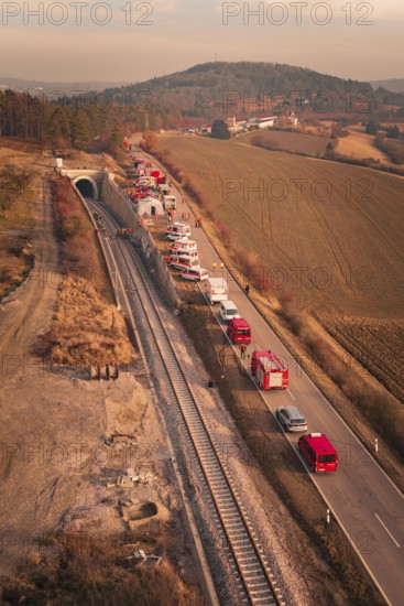 Aerial view of a scenario with emergency vehicles along a tunnel and a road, fire drill at the Hermann-Hesse-Bahn, Ostelsheim, Germany