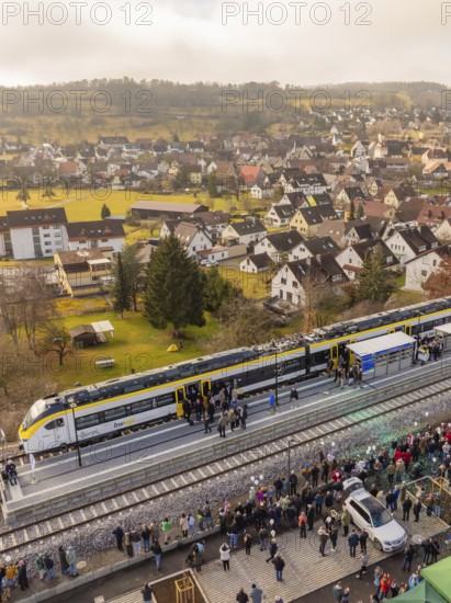 Train stops in a city, people flock onto the platform surrounded by buildings, opening of the Hermann Hesse Railway, Calw, Germany