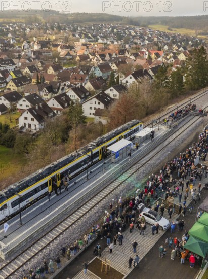 A train stops in a village, many people wait at the platform, opening of the Hermann Hesse Railway, Calw, Germany
