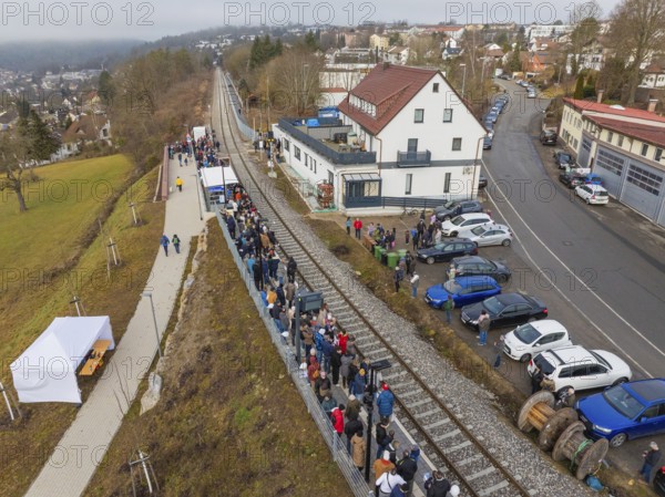A train station with many people, located in an urban area with roads, opening of the Hermann Hesse Railway, Calw, Germany