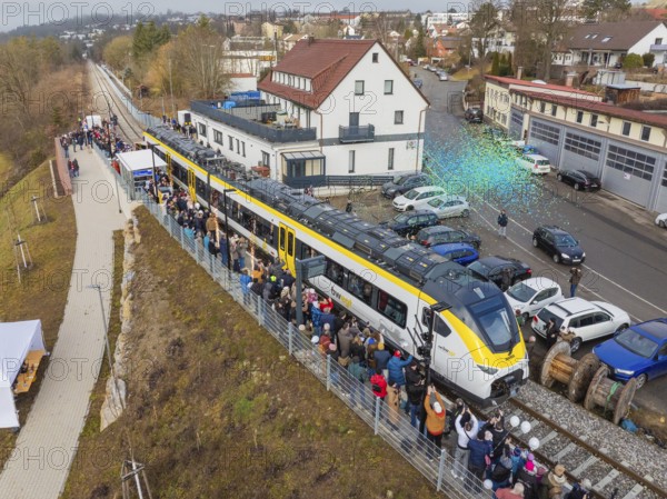 Zug at an event with people and rain of confetti, surrounded by vehicles and buildings, opening of the Hermann Hesse Railway, Calw, Germany