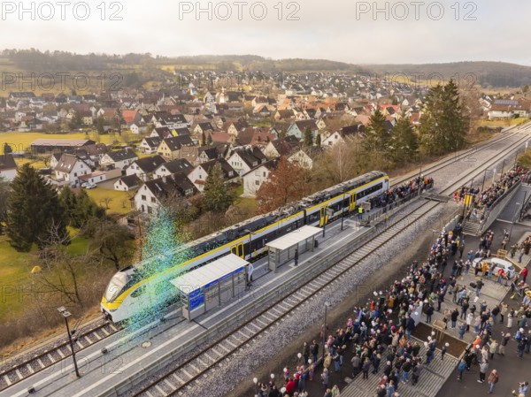 Train arrival at a busy train station with crowds and city views, opening of the Hermann Hesse Railway, Calw, Germany