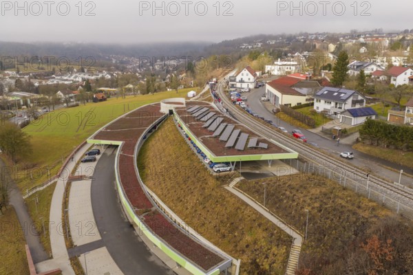 Hill with solar panels and roads in an urban residential area, opening of the Hermann Hesse Railway, Calw, Germany