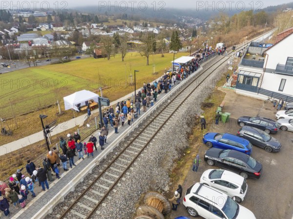 Station with lots of people waiting and parked cars in a rural area, opening of the Hermann Hesse Railway, Calw, Germany