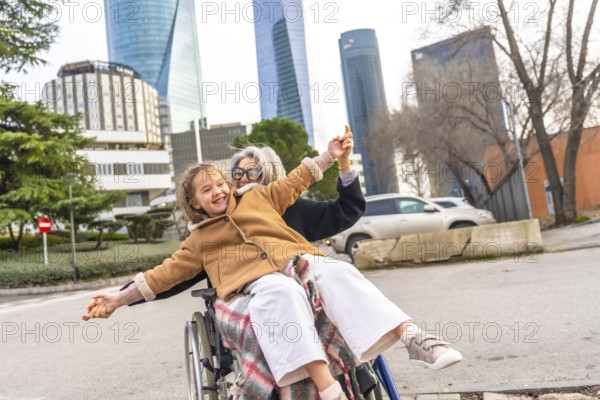 Loving grandmother and granddaughter sharing a joyful moment, playing together while enjoying an outdoor walk on a city street, promoting family connection, happiness, and care