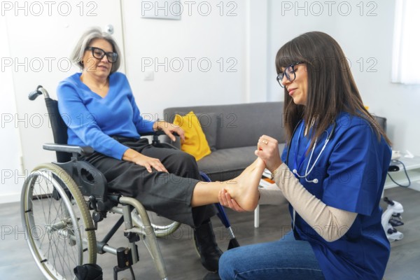 Professional caregiver providing a foot examination and physical therapy to an elderly woman sitting in a wheelchair, focusing on health, rehabilitation, and assisted living support