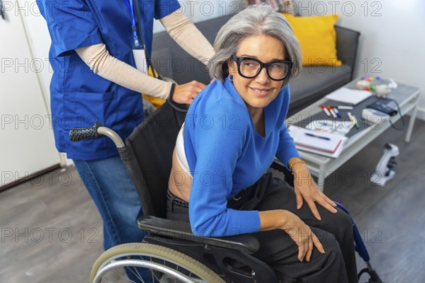 Senior woman in a wheelchair smiling and looking at camera while a professional nurse or caregiver is pushing her from behind in an assisted living environment, focusing on support and care