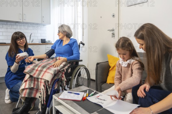 Nurse checks senior woman's blood pressure in wheelchair at home while daughter and grandchild visit and draw, showing multigenerational care, support and everyday well being