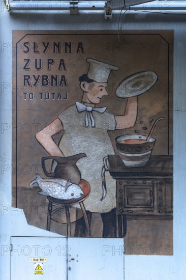 Cook at the stove, mural at a restaurant, Krakow, Poland