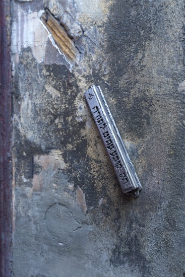 A mezuzah at an entrance to a Jewish house means door post and describes a font capsule on a door post, Krakow, Poland