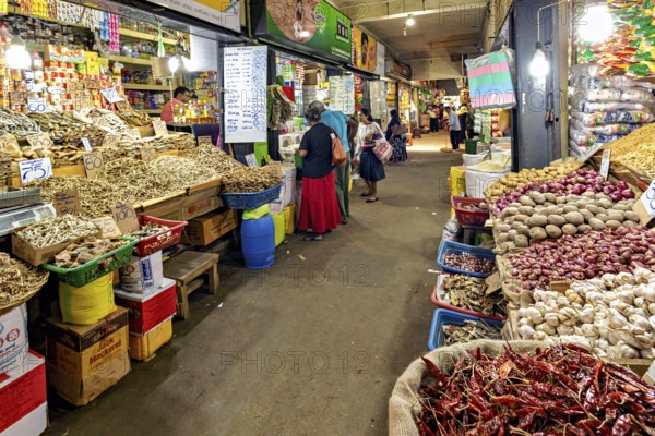 Bustling marketplace full of spices and vegetables with people in narrow corridors, The old market halls of Kandy in Sri Lanka