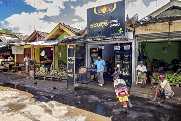 Rural street scene with small shops and people standing on the side of the road, The old market halls of Kandy in Sri Lanka