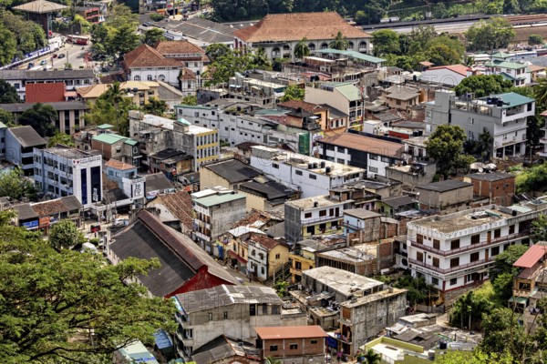 City view with densely built houses, green surroundings and various architectural styles, view of the city center of Kandy in Sri Lanka
