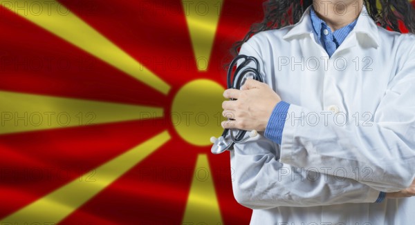 Healthcare professional with North Macedonia flag background. Professional doctor holding stethoscope on North Macedonia flag background