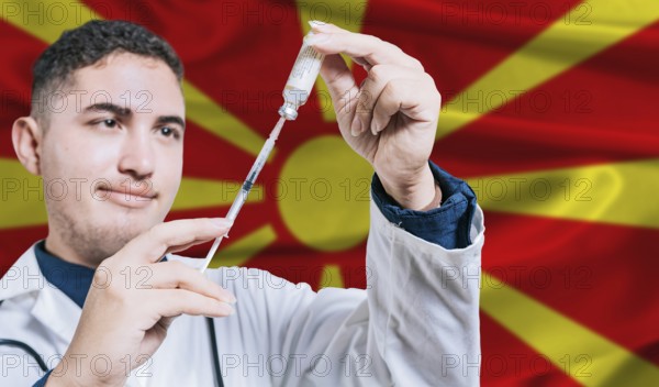Doctor holding syringe on North Macedonia flag background. Medical professional holding syringe with Macedonian flag in the background
