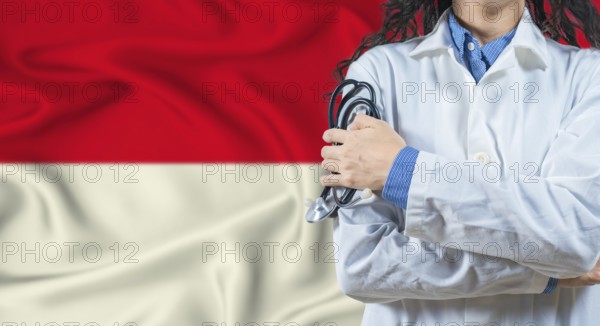 Healthcare professional with Indonesia flag background. Professional doctor holding stethoscope on Indonesia flag background