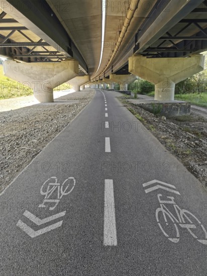 A bicycle path goes under a bridge on an asphalted road, Slovakia