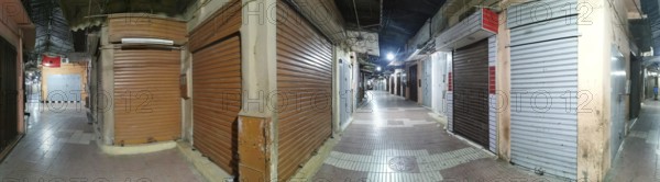 Medina, during Ramadan, darkened market alleys with closed shutters in an urban night atmosphere, Morocco